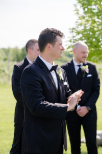 groom crying as he sees his bride walk down the aisle