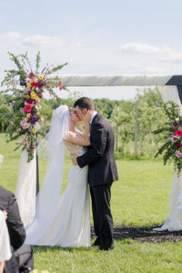 bride and groom share kiss after wedding ceremony at cherry barc farms