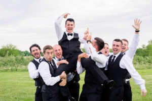 groom with his groomsmen laughing